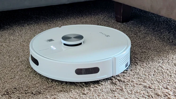 The EzViz RE4 robot vacuum pictured cleaning brown carpet