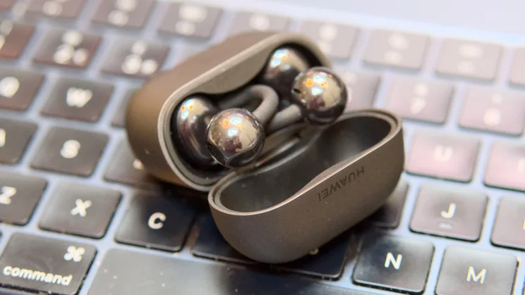 The Huawei FreeClip 2 in their case on a laptop keyboard