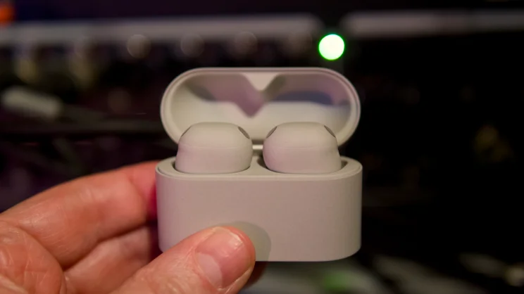 The Sony WF-1000XM6 pictured in their charging case with some LEDs in the background