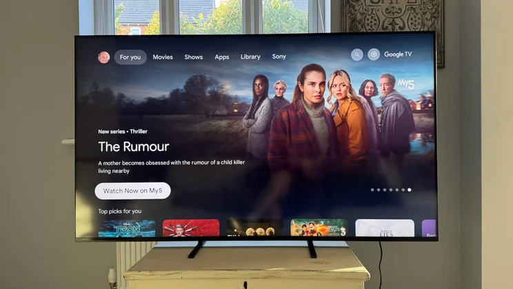 Front view of the Sony Bravia 5 Mini LED TV displaying the Google TV homepage with an advert for The Rumour