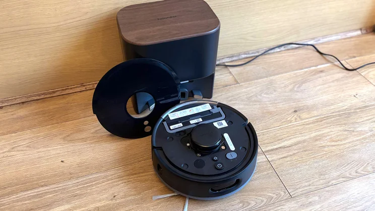 The Switchbot K11+ robot vacuum, with lid off, and its base - viewed from above