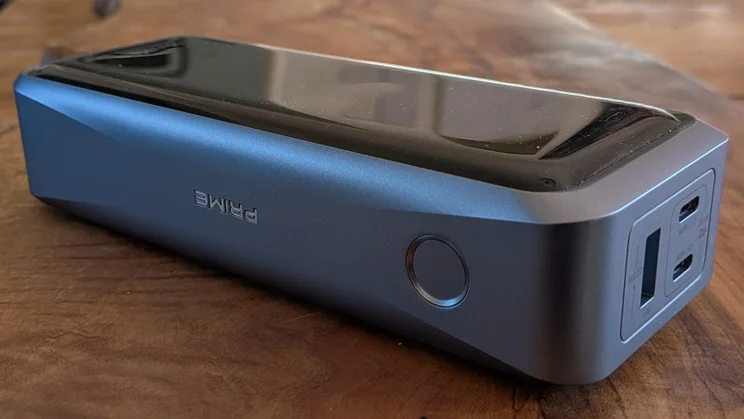 The Anker Prime A110A shown on a wooden table with its single control button facing the camera