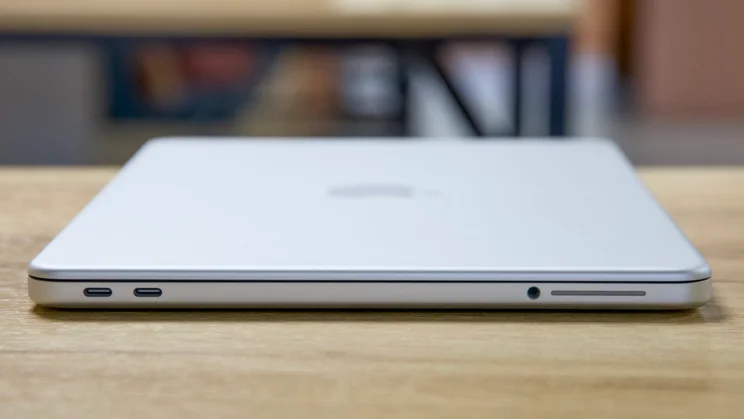 Apple MacBook Neo in silver, closed, pictured from left side