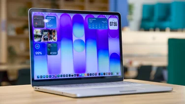 Apple MacBook Neo in silver, open, pictured from the front left quarter