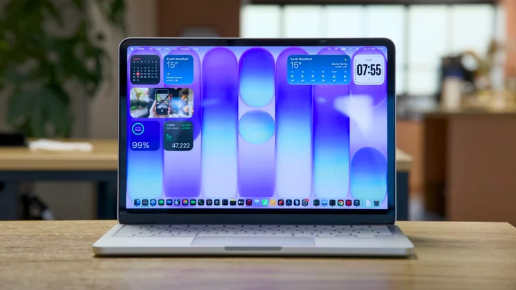 Apple MacBook Neo in silver, open, pictured from the front