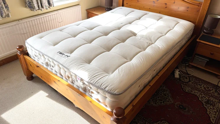 The REM-Fit Natural Lux Hybrid mattress on a bed in a bedroom