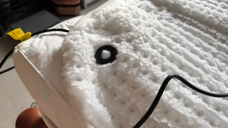 A closeup of the Beurer Indulgence Heated Underblanket's bottom corner, and cable connector