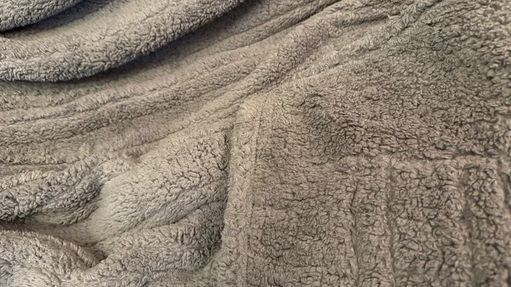 A closeup of the Dunelm Teddy Electric Throw's surface and corner