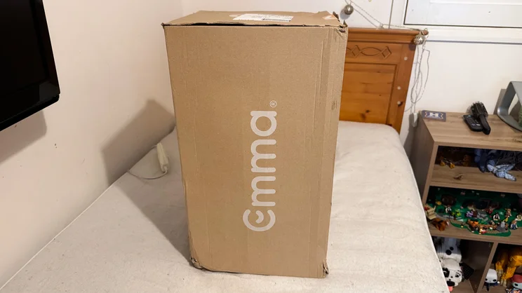 The Emma All Seasons Customisable Duvet packaged in its box, on top of a single bed