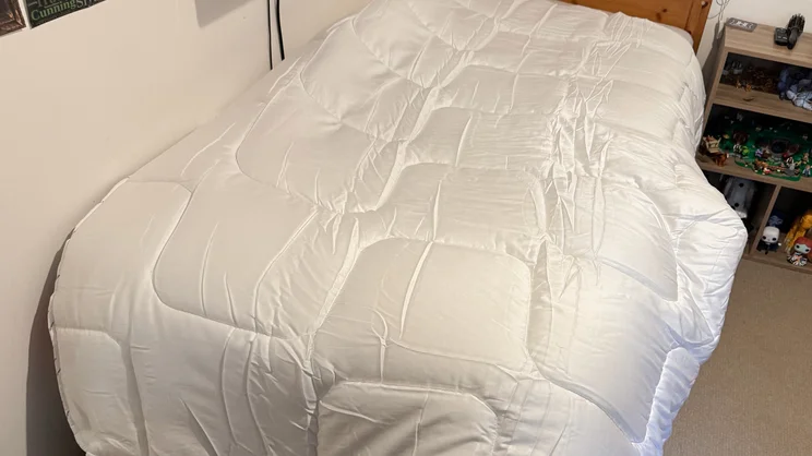 The Emma All Seasons Customisable Duvet on a single bed in a bedroom