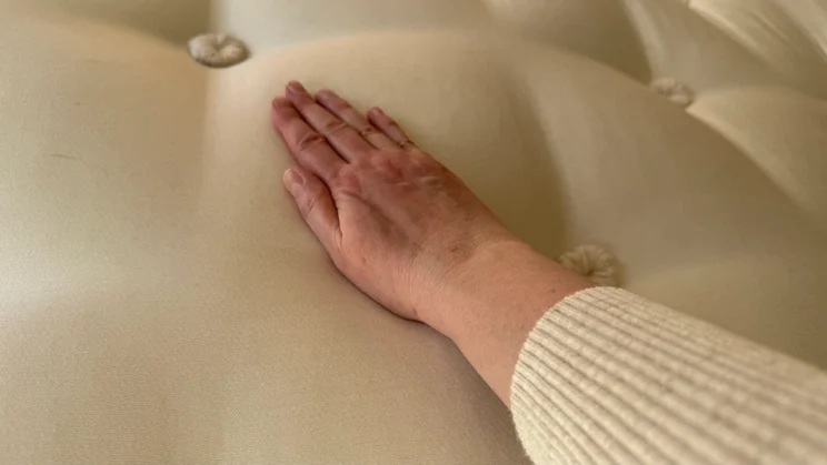 Happy Beds The Annabel 2000 Pocket Spring Natural Pillowtop mattress - close up of top layer with photographer's hand resting on it