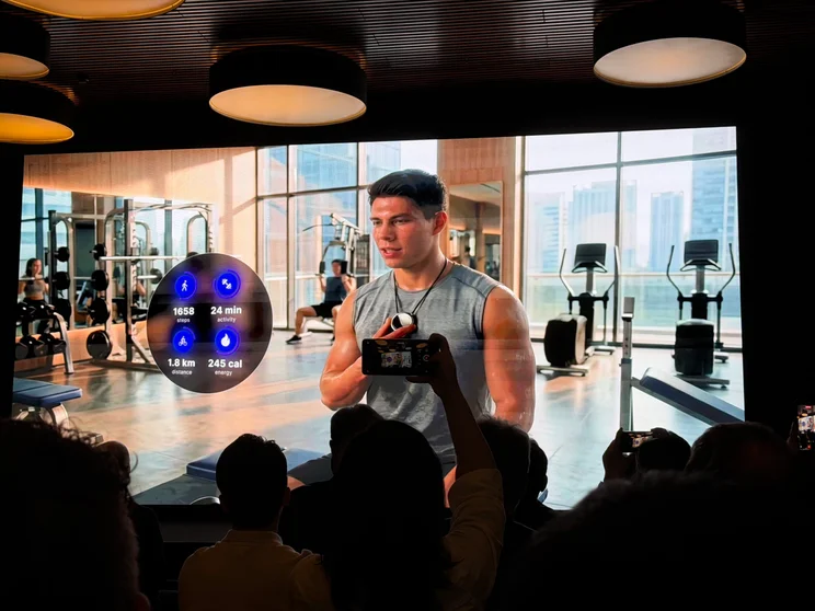 A slide from the Qualcomm Wear Elite presentation at MWC 2026 showing someone working out at the gym wearing an smart ai pendant