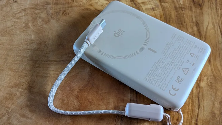 The Iniu SnapGo Air power bank with its integrated cable half detached
