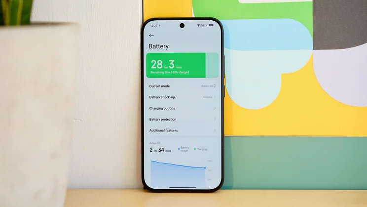 Poco X8 Pro leaning against a wall, displaying battery settings