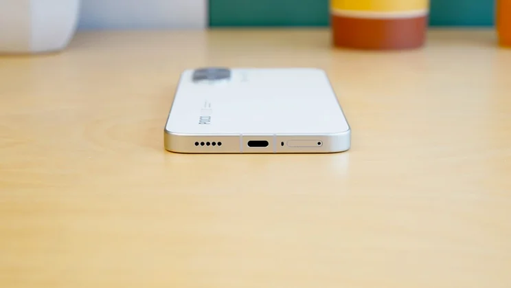 Poco X8 Pro Max face down on a table, bottom view