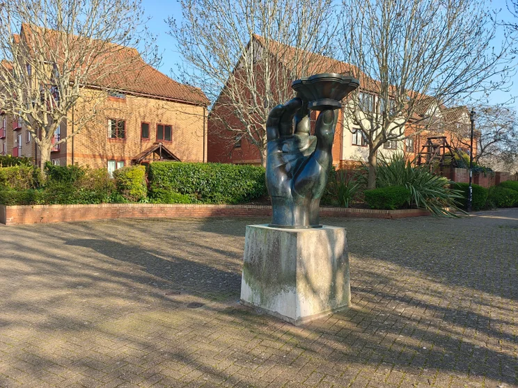 A sculpture with houses in the background
