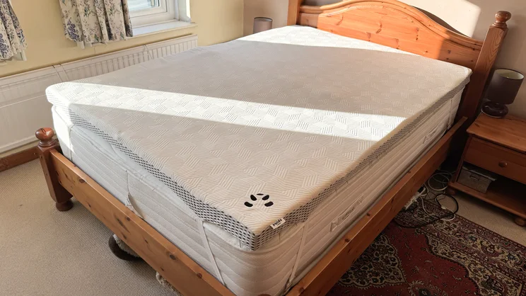 The Simba Hybrid bamboo mattress topper on a bed in a bedroom
