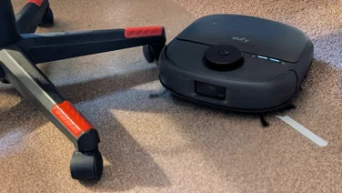 The Eufy Omni C28 pictured cleaning around the legs of an office chair
