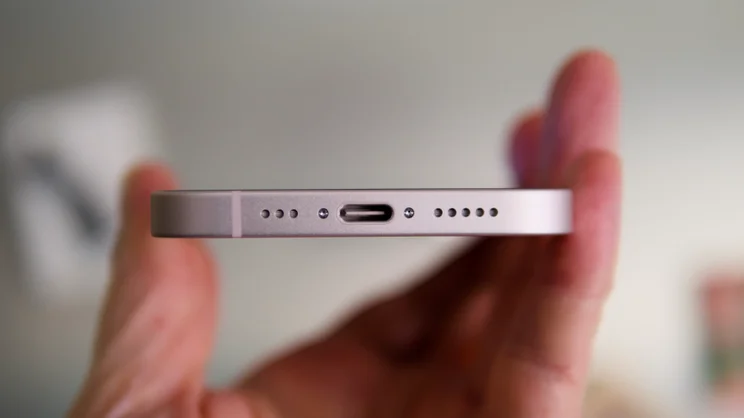 The bottom edge of the Apple iPhone 17e, in soft pink