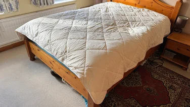 The Woolroom Deluxe Washable 3-in-1 Wool duvet on a bed in a bedroom