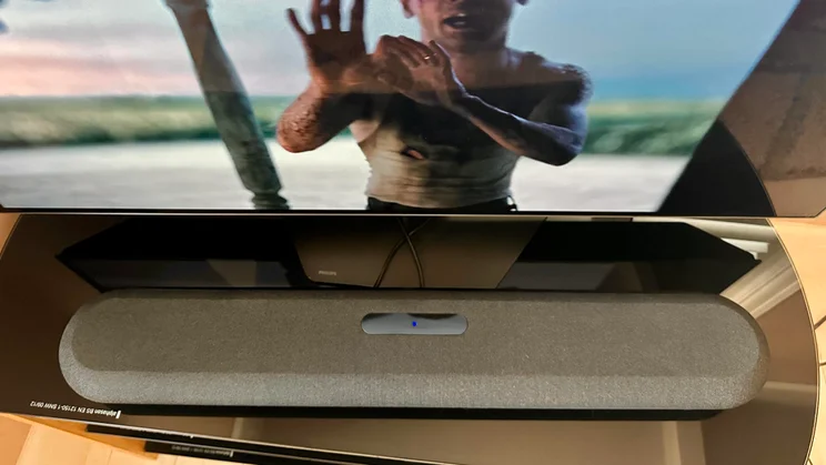 Top-down view of the Bluesound Pulse Cinema Mini soundbar in front of a Philips television
