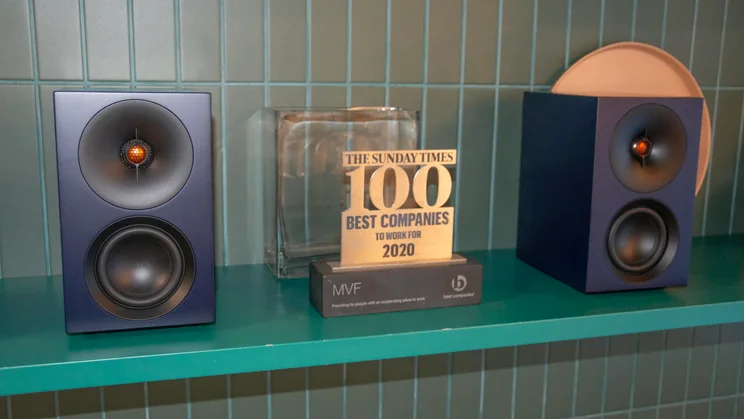 The Cambridge Audio L/R S active speakers on a shelf with a trophy in between them