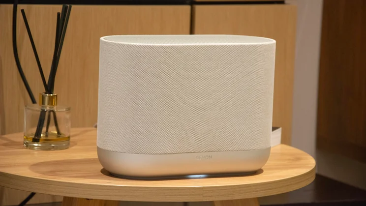 The Denon Home 400 wireless speaker on a wooden table
