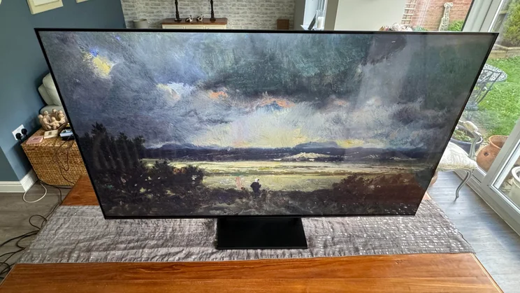 Top-down view of the Hisense U7Q Pro Mini LED TV displaying artwork depicting a moody natural landscape