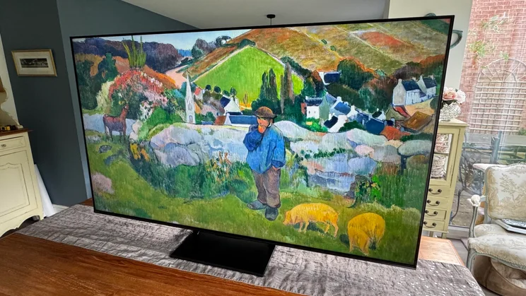 View of the Hisense U7Q Pro Mini LED TV from the right-hand side displaying a pastoral artwork on screen