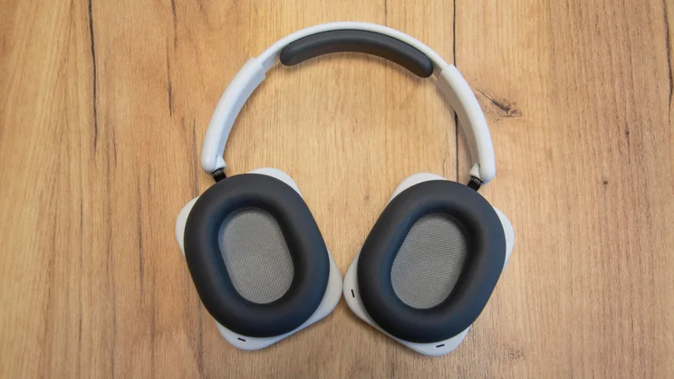 The Nothing Headphone (a) over-ear headphones on a wooden table with their earpads facing upwards