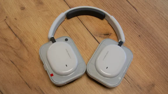 The Nothing Headphone (a) over-ear headphones on a wooden table