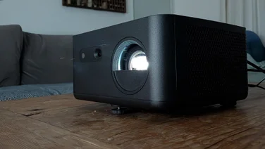 The Optoma Photon Life PK32 projector on a wooden table