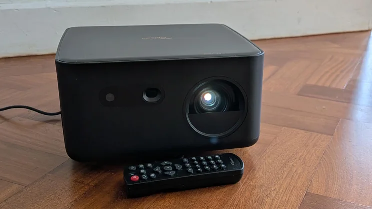 Front view of the Optoma Photon Life PK32 projector on a wooden floor