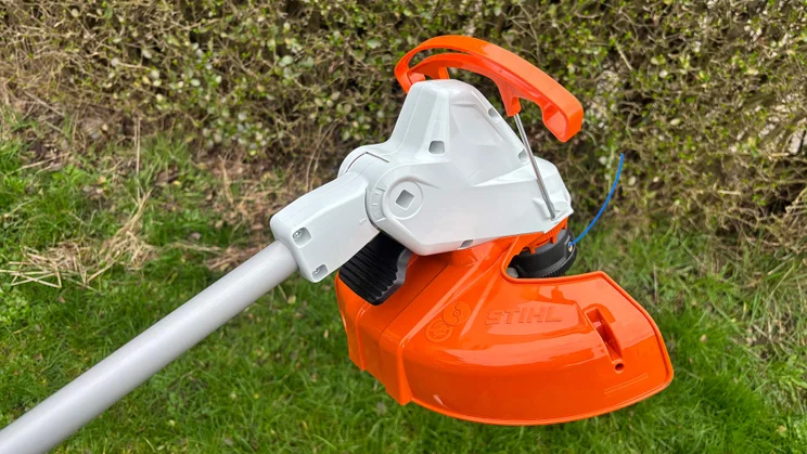 A closeup of the Stihl FSA 50 grass trimmer's cutting head, with head guard retracted