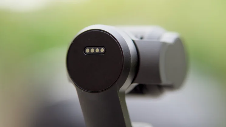 A close up of the rear of the DJI OSMO Pocket 4 lens housing, showing the contact points for accessory attachment