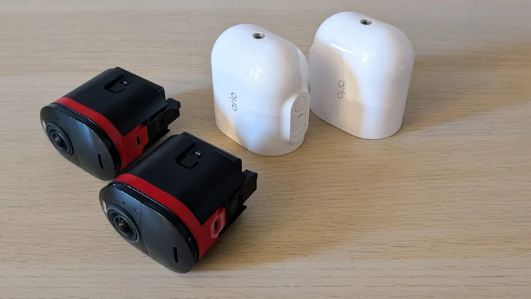 A pair of Arlo Ultra 3 security cameras with batteries removed