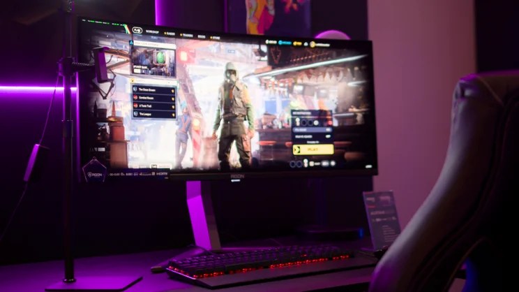 A photo of the AOC Agon Pro AGP34UCSD gaming monitor on the stand at a press event