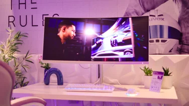 A photo of the Philips Evnia 34M2C8600P gaming monitoron the stand at a press event