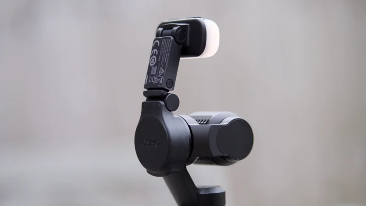 A rear view of the DJI OSMO Pocket 4 with optional fill light attached