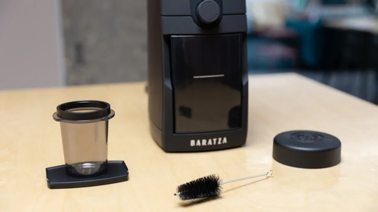 The Baratza Encore ESP Pro coffee grinder on a kitchen surface, alongside its accessories