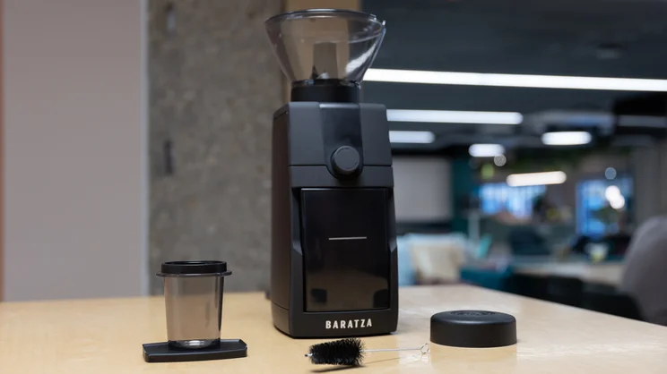 The Baratza Encore ESP Pro coffee grinder on a kitchen surface, alongside its accessories