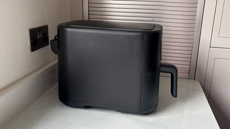 A side view of the Cuisinart Compact Max Air Fryer, on a kitchen worktop
