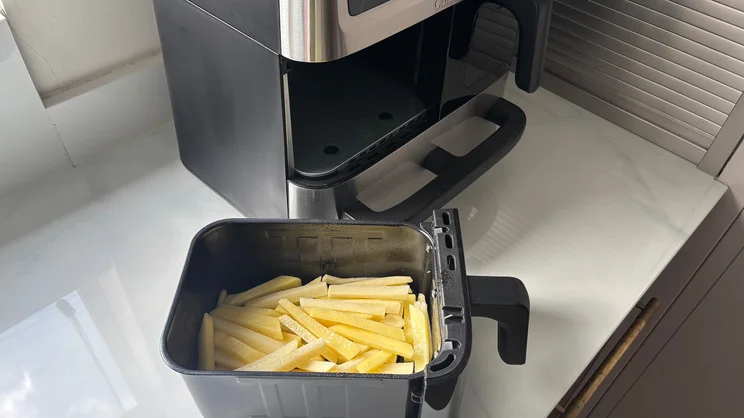 Raw chips inside one of the Cuisinart Tri Zone 13.6l Air Fryer & Oven's drawers