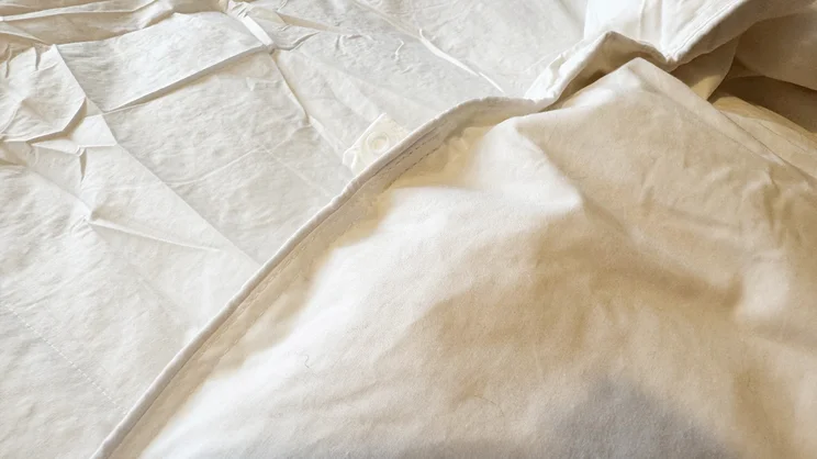 A closeup of the Dusk Luxury 80% Goose Down duvet edge and fastener