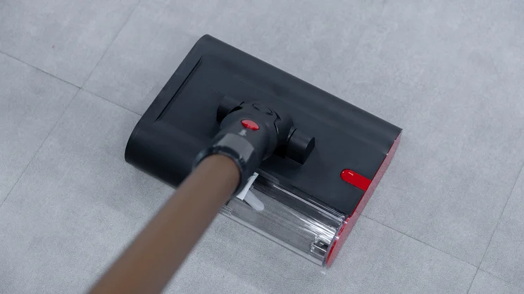 A closeup of the Dyson PencilWash hard floor cleaner's cleaning head on an office floor