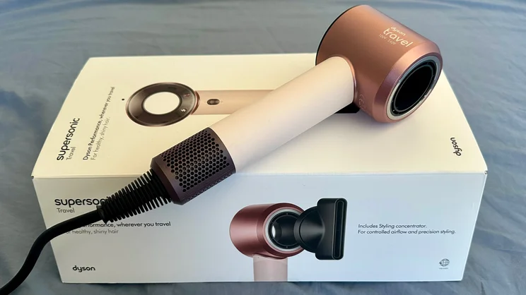 The Dyson Supersonic Travel hair dryer lying on its box