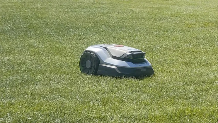 The EGO Aura R2 robot lawn mower cutting a lawn