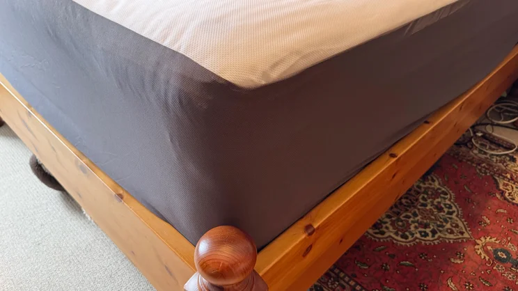 A closeup of the Emma Mattress Protector's corner, on a mattress