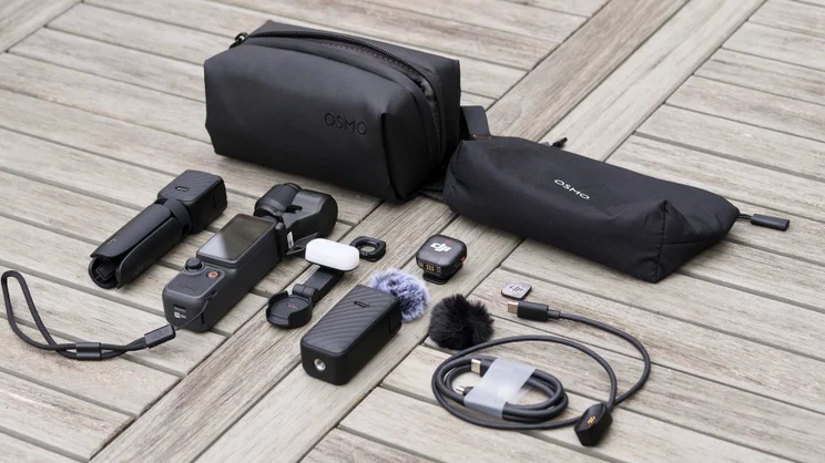 Everything that comes with the DJI OSMO Pocket 4 Creator Combo, laid out on a garden table