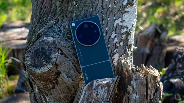 Oppo Find X9 Ultra upright on a tree stump, rear view